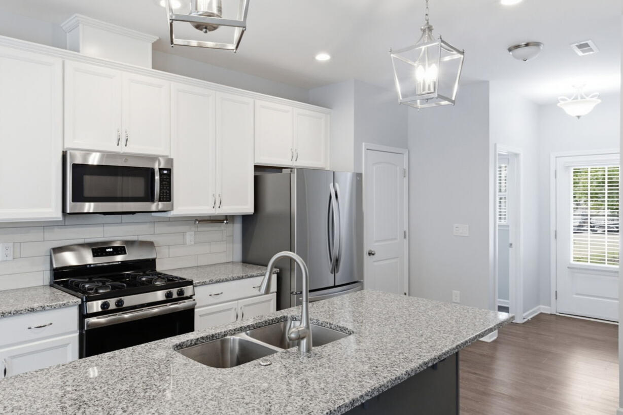Kitchen with granite island and stainless appliances in the Garner, NC townhouse rental