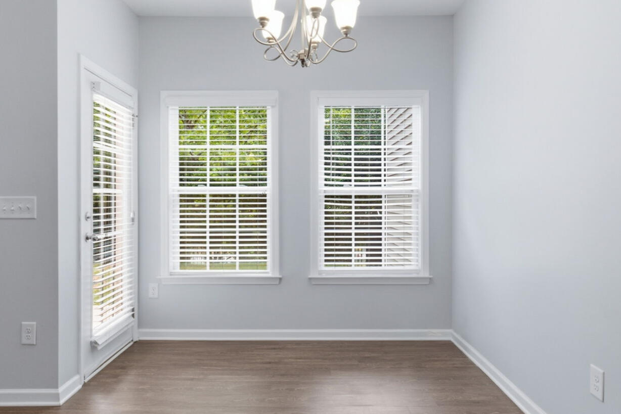 Dining area with round table and chandelier in the Garner townhouse rental