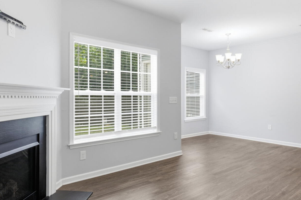 Living room with fireplace and large window in the Garner, NC townhouse rental