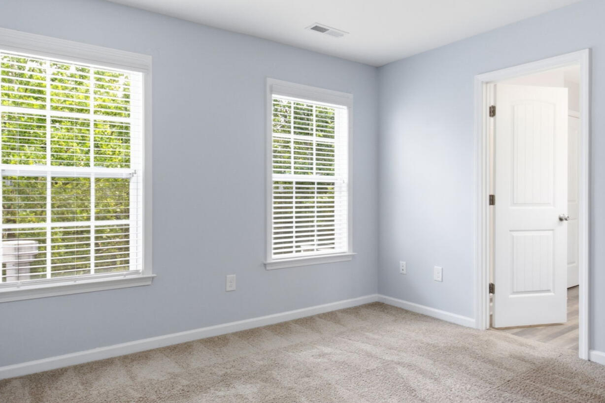 Second bedroom with windows and hallway access in the Garner, NC townhouse rental
