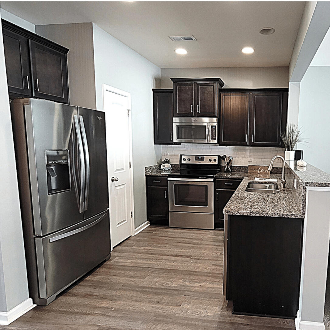Kitchen with stainless steel appliances and granite counters in the Wake Forest rental home
