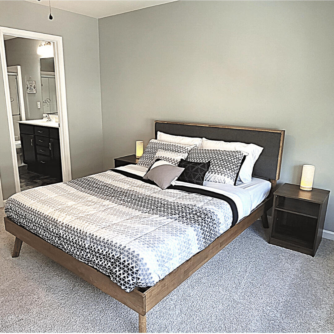 Bedroom with queen bed and closet in the furnished Wake Forest rental