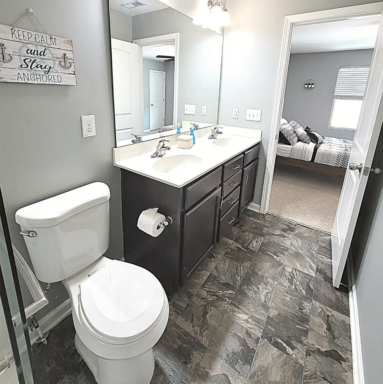 Bathroom vanity opening onto a carpeted bedroom in the Wake Forest rental